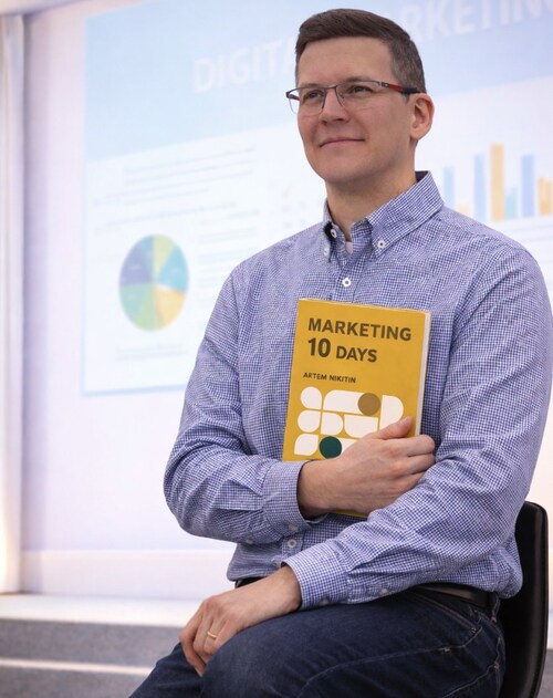 Artem Nikitin, marketing strategist and author of Marketing in 10 Days, holding the book.