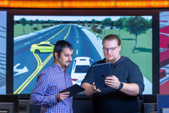 Professor Hanif Rahbari, left, and Ph.D. student Geoff Twardokus are creating a digital twin of connected vehicles on the roadway. Using this, they can put quantum-resistant cryptography to the test.